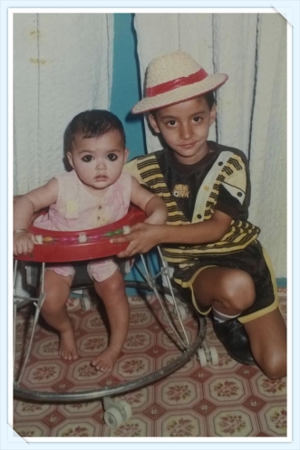 My first picture with my brother .. I am 8 months old and he is 5
